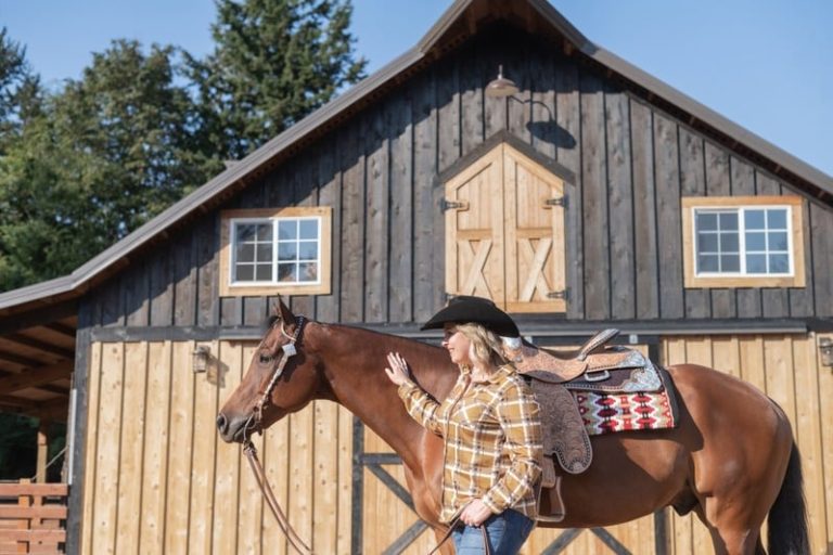 Brandi Coplen with her horse in front of a barn in Whatcom County