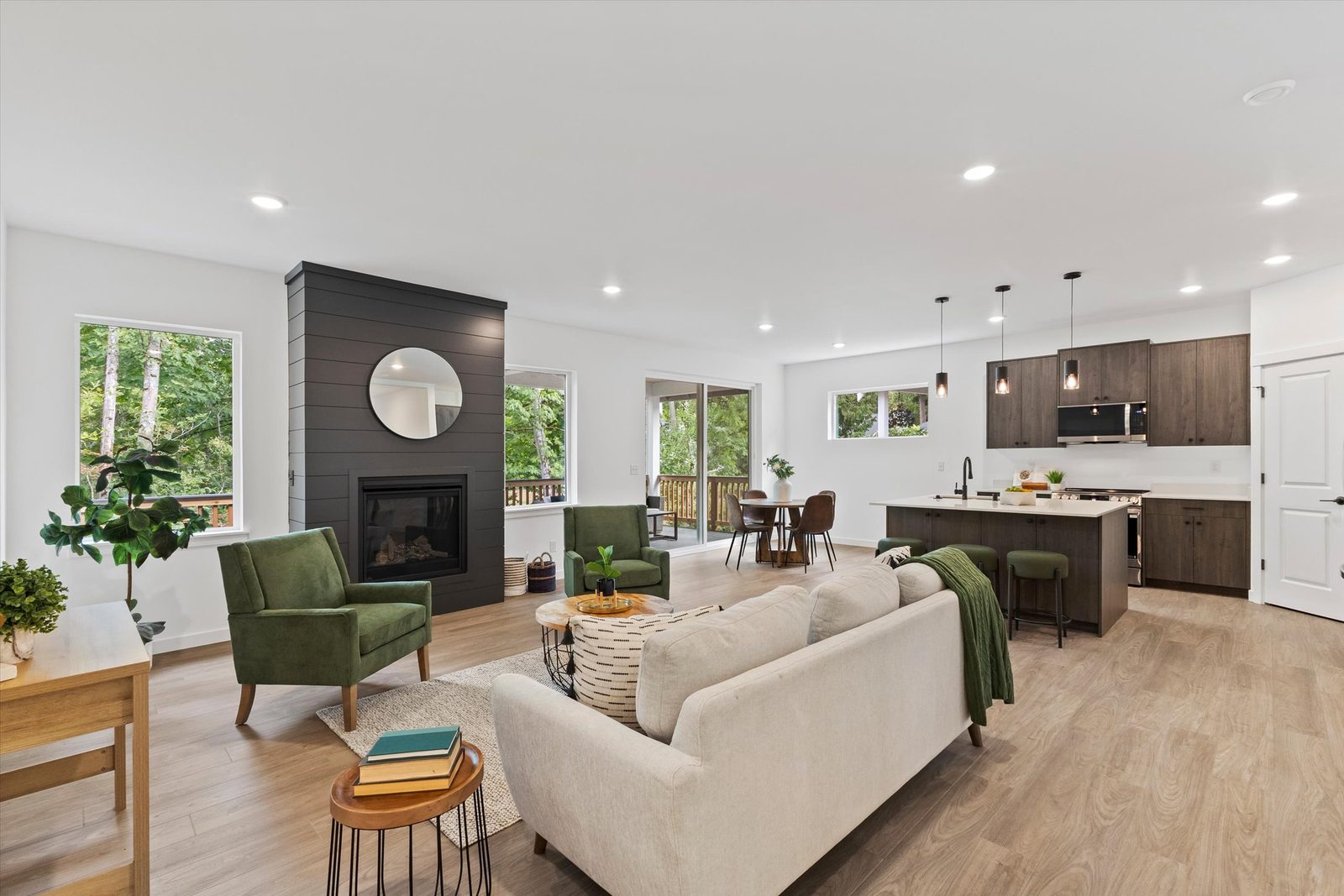 Open great room with gas fireplace and kitchen island in a home at The Ridge at Harbor Hills, Blaine, WA