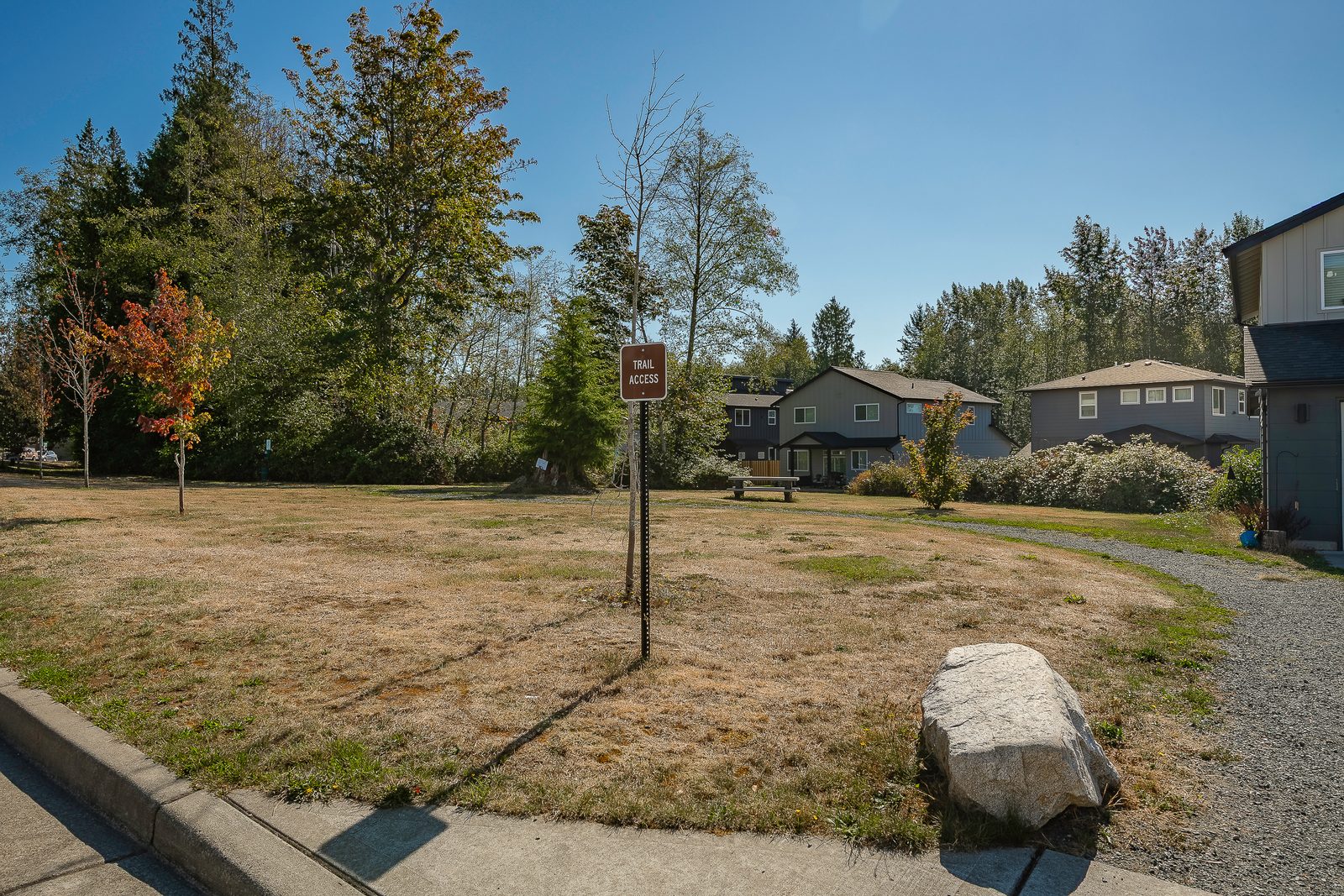Trail access and open green space with a picnic table at The Ridge at Harbor Hills in Blaine, WA